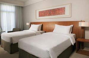 A bed or beds in a room at K108 Hotel Doha