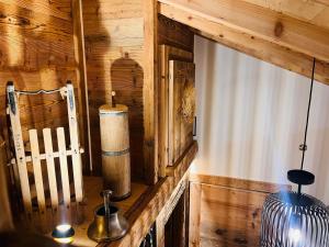 a room with a wooden wall and a vase on a table at Chalet du Lac in Charmey +76 photos