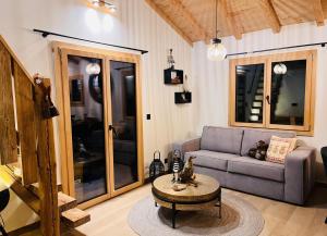 a living room with a couch and a table at Chalet du Lac in Charmey