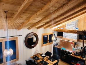 an office with a desk and chairs and a mirror at Chalet du Lac in Charmey