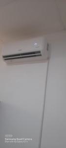 a white refrigerator freezer sitting in a room at Lankadays in Negombo