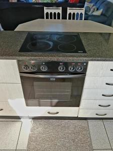 a stove top oven sitting in a kitchen at Happy Jack - Margate in Margate +12 photos