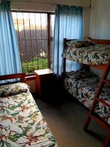 a room with two bunk beds and a window at Happy Jack - Margate in Margate