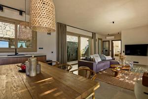 a living room with a table and a couch at Villa Noema in Agiassos
