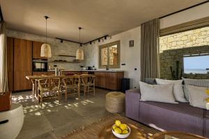 a living room and kitchen with a purple couch at Villa Noema in Agiassos