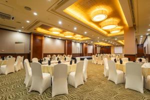 a conference room with white tables and chairs at The Alpha Suites in Manila