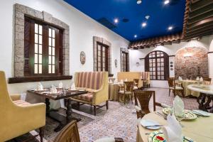 a restaurant with tables and chairs in a room at The Alpha Suites in Manila