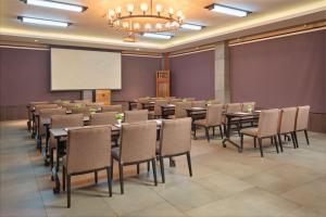 a conference room with tables and chairs and a projection screen at Two Seasons Coron Bayside Hotel in Coron +57 photos