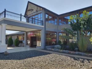 a large building with a balcony on top of it at OLOIRIEN HOTEL & RESORT in Narok