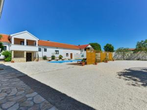 a villa with a swimming pool and a house at Marinic Comfortable holiday residence in Zadar