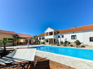a villa with a swimming pool and a house at Marinic Comfortable holiday residence in Zadar