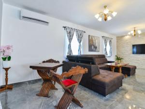 a living room with a couch and a table at Marinic Comfortable holiday residence in Zadar