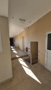 a hallway of an empty room with light shining on the wall at Hotel La Giralda CAZ in Vera
