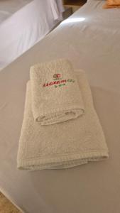 a pair of towels sitting on top of a bed at Hotel La Giralda CAZ in Vera +39 photos