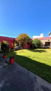 a green yard with a red building and a building at Hotel La Giralda CAZ in Vera