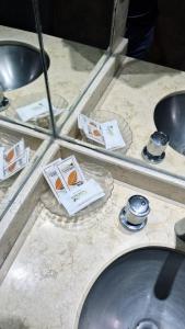 a counter with a sink with cards on it at Hotel La Giralda CAZ in Vera