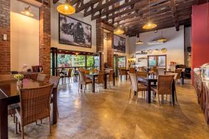a dining room with tables and chairs in a restaurant at Nkomazi Kruger Lodge & Spa in Malelane