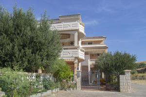 a house with a gate in front of it at Sladana direct at the beach in Metajna