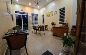 a living room with a table and a dining room at Rooftop View Home in Kampot +49 photos