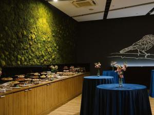 a buffet line with two blue tables with food at ibis Styles Bialystok in Białystok