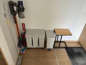 a room with two machines and a table at shine house warabi2 in Warabi