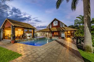 a home with a swimming pool and a house at Nkomazi Kruger Lodge & Spa in Malelane