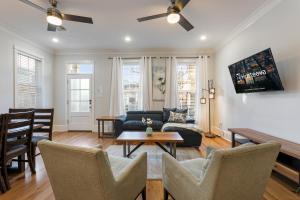 a living room with a couch and a table at Stunning 4BR-5BR near French Quarter Homes by Hosteeva in New Orleans