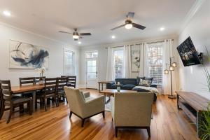 a living room with a table and a dining room at Stunning 4BR-5BR near French Quarter Homes by Hosteeva in New Orleans