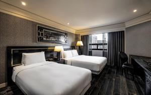 a hotel room with two beds and a desk at Kensington Hotel Yeouido in Seoul +70 photos