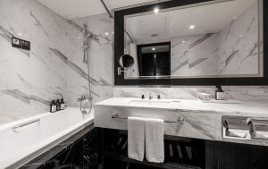 a bathroom with a sink and a mirror at Kensington Hotel Yeouido in Seoul