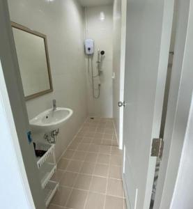 a white bathroom with a sink and a mirror at Kata Sea Blue in Kata Beach +24 photos