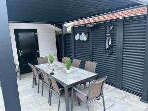 a table and chairs sitting on a patio at Seehund 102 in Sint Annaland +20 photos