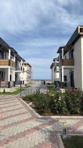 a row of houses on the beach near the ocean at Берег 2 in Bosteri
