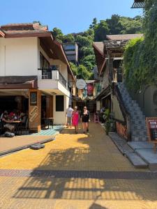 a group of people walking down a street at Aura Hotel Phi Phi in Phi Phi Islands