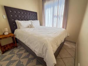 a bedroom with a large bed with a large window at 28 Breaker View 3-bedroom beach apartment in Durban