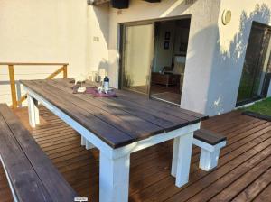 a wooden picnic table sitting on a deck at Waves End Holiday Home in Southbroom +37 photos