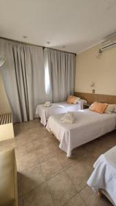 two beds sitting in a room with curtains at Hotel La Giralda CAZ in Vera