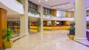 a lobby with columns and plants in a building at Aquasis De Luxe Resort & SPA - Ultra All Inclusive in Didim +147 photos