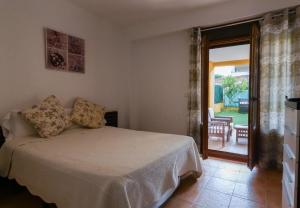 a bedroom with a bed and a sliding glass door at Costa Esuri in Ayamonte +19 photos