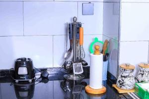 a kitchen counter with utensils on a counter top at Elite properties in Kampala