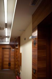 a hallway with wooden doors in a building at Garni Hotel Centar in Novi Sad