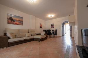 a living room with a couch and a table at Costa Esuri in Ayamonte