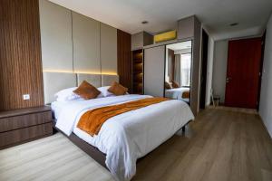 a bedroom with a large bed in a room at Norm Villa Kuta in Kuta