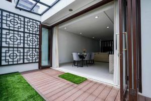 a patio with a table and chairs on a deck at Norm Villa Kuta in Kuta