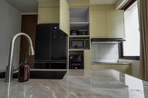 a kitchen with a counter top and a sink at Norm Villa Kuta in Kuta +53 photos