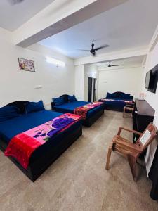 a living room with two beds and a couch at G Mount inn in Munnar