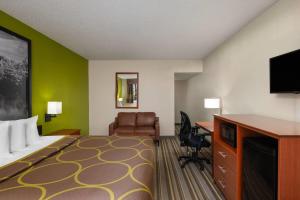 a hotel room with a bed and a desk at Super 8 by Wyndham Lake City in Lake City +50 photos