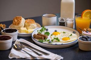a table topped with plates of eggs and breakfast foods at Super 8 by Wyndham Lake City in Lake City