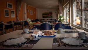 a table with a plate of food in a restaurant at Ostello Città di Rovereto in Rovereto