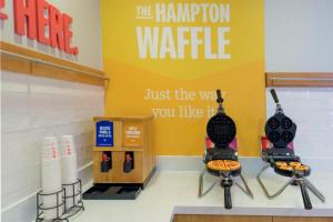 a store with two hot dogs and a sign that reads the hampton waffle at Hampton Inn & Suites-Austin Airport in Austin +12 photos